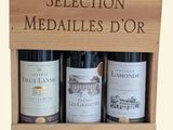 three bottles of wine in a wooden box