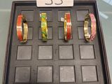 three bracelets in a display case on a glass table