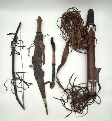 several different types of weapons on display on a white surface