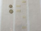several different types of coins are displayed on a white surface