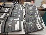 a lot of telephones that are on a table