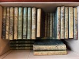 many old books in a box on the shelf