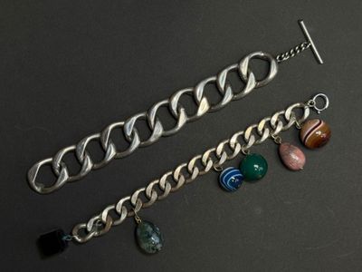a close up of a chain bracelet with charms on it