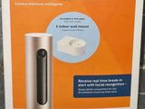 the box of a smart indoor camera sits on the floor