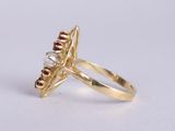 an image of a gold ring with a red and white diamond
