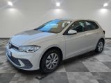a white volkswagen golf parked in a room with a checkered floor