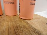three plastic cups sitting on top of a wooden table
