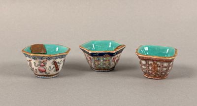 three small cups are lined up in a row on a gray surface