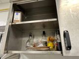a metal cabinet with bottles and other items in it