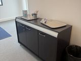 a picture of a bathroom with two sinks and a trash can