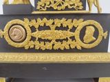 a black and gold clock with gold decorations on it