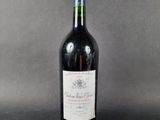 a picture of a bottle of red wine on a grey background