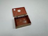 a small wooden box that has a sticker on it