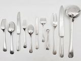 a lot of silverware on a table with a spoon and fork