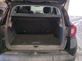 the back of a car with its trunk open in a parking lot