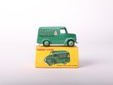 a green toy truck sitting on top of a yellow box