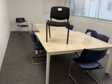 a room with a table and chairs in it