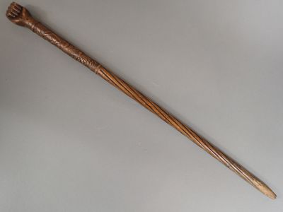 an old wooden stick with a handle on a white surface