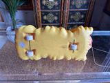 a yellow skateboard sitting on top of a glass table