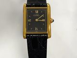 an image of a black and gold wrist watch with roman numerals