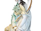 an image of a statue of a woman sitting on a chair