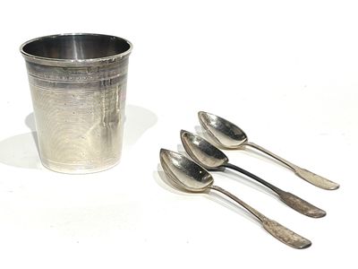 three spoons and a cup on the table