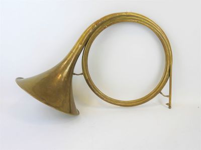 an old brass trumpet with a brass bell on a white background