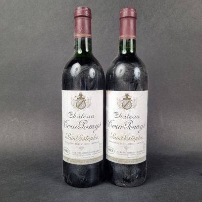 two bottles of red wine sitting next to each other on a table