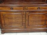 a wooden cabinet with a mirror on top of it
