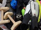 a bucket full of sports gear and a helmet on the table