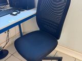 a desk with a computer and a chair in front of it