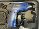 a blue electric drill in a box with wires