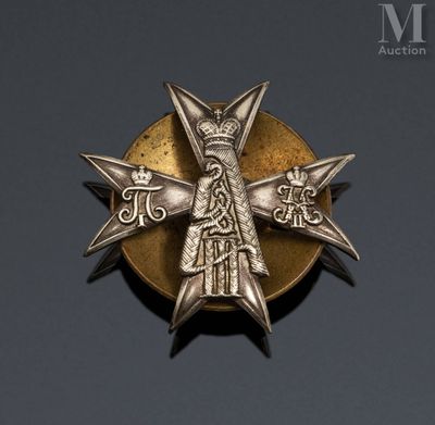 a close up of a metal badge with a cross on it