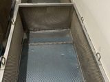 two bins that are in the floor of a room