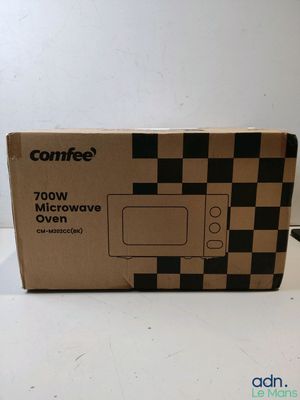 an open box of microwave oven sitting on top of a counter