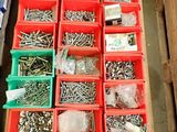 many different types of screws and nuts in red bins