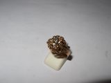 a close up of a gold ring on a white surface