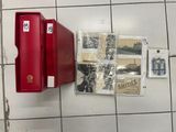 a red box that is sitting on a tiled floor
