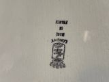 a white plate with a black and white picture on it