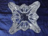 an image of a clear glass object on a blue cloth