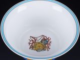 a white bowl with a blue border and a picture of a bird on it