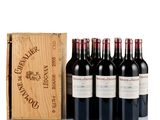 six bottles of red wine in a wooden box next to a wooden box