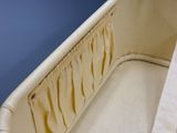 a baby crib with a white cover and a blue background