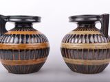 two vases sitting next to each other on a table
