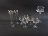 a lot of wine glasses and a vase on the table