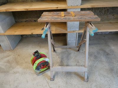 a workbench with tools on top of it in a garage