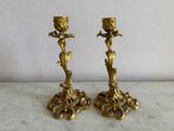 pair of antique brass candlesticks on marble table