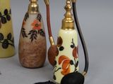 three different types of perfume bottles with tassels on them