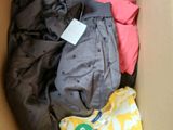a cardboard box filled with clothes and a tag on it