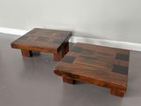 two wooden tables with black and white squares on them in a room